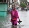 A woman walks through flood waters in Pakistan