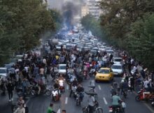Protesters burn fires in the street in Tehran