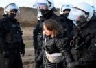 Greta Thunberg being led away by German police